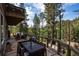 Outdoor dining and lounge area on the backyard stone patio at 4978 Camel Heights Rd, Evergreen, CO 80439