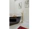 Close-up of a freestanding black soaking tub with gold faucet and decorative accents at 4978 Camel Heights Rd, Evergreen, CO 80439
