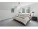 Bright bedroom featuring large windows, modern lighting, and comfortable bed at 4978 Camel Heights Rd, Evergreen, CO 80439