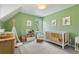 Cozy green bedroom with a crib, rocking chair, and decorative teepee for a  at 4978 Camel Heights Rd, Evergreen, CO 80439