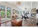 Bright bonus room featuring gym equipment, French doors, fireplace and outdoor views at 4978 Camel Heights Rd, Evergreen, CO 80439