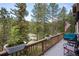 Inviting deck with comfortable seating, an American flag, and views of nature at 4978 Camel Heights Rd, Evergreen, CO 80439
