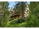 Expansive exterior of a rustic style home with lush surroundings at 4978 Camel Heights Rd, Evergreen, CO 80439