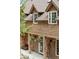 Inviting front entry with hanging flower baskets, a bench, and rustic accents at 4978 Camel Heights Rd, Evergreen, CO 80439