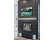 Close-up of a modern fireplace with herringbone tile, a wooden mantel, and elegant glass candle holders at 4978 Camel Heights Rd, Evergreen, CO 80439