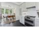 Bright kitchen boasts modern appliances, marble countertops, and access to dining room at 4978 Camel Heights Rd, Evergreen, CO 80439