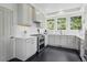Modern kitchen with white cabinets, stainless steel appliances, and beautiful tile flooring, creating a stylish and functional space at 4978 Camel Heights Rd, Evergreen, CO 80439