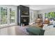 Elegant living room with a fireplace, hardwood floors, and French doors that lead to a balcony at 4978 Camel Heights Rd, Evergreen, CO 80439