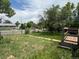 Backyard featuring lush grass, a small wooden deck, and a charming view of the neighborhood at 1105 S Raleigh St, Denver, CO 80219