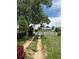 Long driveway leading to the property, framed by greenery and a glimpse of the neighborhood at 1105 S Raleigh St, Denver, CO 80219