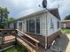 Side view of a home in need of repairs, showcasing a wooden ramp and flaking paint at 1105 S Raleigh St, Denver, CO 80219