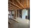 Inside a project house, revealing exposed studs, beams, unfinished floors, and black sheathing at 1105 S Raleigh St, Denver, CO 80219