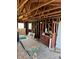 Home interior under construction with exposed wooden framing, construction debris, and a vintage cabinet at 1105 S Raleigh St, Denver, CO 80219