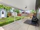 Covered patio extends to a well-maintained backyard featuring a shed, privacy fence, and ample greenery at 6223 Gray St, Arvada, CO 80003