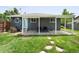 Inviting backyard featuring a covered patio, lush lawn, and stylish outdoor seating, perfect for relaxation at 6223 Gray St, Arvada, CO 80003