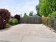 Wide backyard gate leading to a large concrete parking area behind a wood fence at 6223 Gray St, Arvada, CO 80003