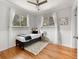 Bedroom with hardwood floors, white wainscoting, neutral walls and plenty of natural light at 6223 Gray St, Arvada, CO 80003