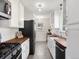 Modern kitchen with stainless steel appliances, white cabinetry, and butcher block countertops at 6223 Gray St, Arvada, CO 80003