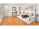 Spacious living room with hardwood floors, comfortable seating, and bright light at 6223 Gray St, Arvada, CO 80003