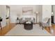 Open living room with hardwood floors and a cozy seating area at 6223 Gray St, Arvada, CO 80003