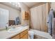 Standard bathroom with a shower and tub combo, and wood-trimmed vanity at 13275 Holly St # E, Thornton, CO 80241