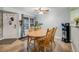 Bright dining area featuring a wooden table with seating for four and a window with natural light at 13275 Holly St # E, Thornton, CO 80241