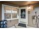 Welcoming front porch with a charming door, complemented by attractive decor and ample natural light at 13275 Holly St # E, Thornton, CO 80241