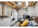 Unfinished basement area containing laundry machines and storage at 13275 Holly St # E, Thornton, CO 80241