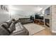 Spacious living room with a cozy fireplace, comfortable seating, and plenty of room to relax at 13275 Holly St # E, Thornton, CO 80241