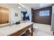 Bathroom featuring double sink vanity, tile flooring, and shower with wood-style tile surround at 424 Peery Pkwy, Golden, CO 80403