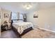 Neutral-toned bedroom with a comfortable bed, soft carpet, and natural light from two windows at 424 Peery Pkwy, Golden, CO 80403