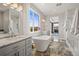 Bright bathroom featuring marble floors, soaking tub, and dual vanities at 19887 Kershaw Ct, Monument, CO 80132