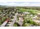 Residential area with houses, green spaces, and a clear blue sky at 3322 Simms St, Wheat Ridge, CO 80033