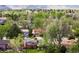Panoramic aerial shot showcases a suburban neighborhood with lush trees and mountain views at 3322 Simms St, Wheat Ridge, CO 80033