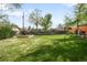 Expansive backyard featuring a lush green lawn and raised garden beds, perfect for outdoor enjoyment at 3322 Simms St, Wheat Ridge, CO 80033