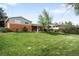Spacious backyard featuring a lush green lawn, perfect for outdoor activities and relaxation at 3322 Simms St, Wheat Ridge, CO 80033