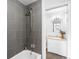 Updated bathroom features a tub with gray tile shower at 3322 Simms St, Wheat Ridge, CO 80033