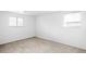 Cozy bedroom featuring neutral carpet, white walls, and two bright windows at 3322 Simms St, Wheat Ridge, CO 80033
