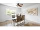 Bright dining room features stylish ceiling fan, modern table and chairs, and large window at 3322 Simms St, Wheat Ridge, CO 80033