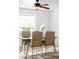 Natural lighting fills this dining room with modern table and chairs at 3322 Simms St, Wheat Ridge, CO 80033