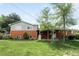 Charming brick home with a well-maintained lawn and mature trees providing shade and curb appeal at 3322 Simms St, Wheat Ridge, CO 80033