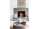 Elegant stone fireplace, the focal point of this cozy living room with a decorative mantel at 3322 Simms St, Wheat Ridge, CO 80033