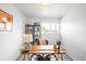 Bright office with modern desk, decorative rug, and natural light from the window at 3322 Simms St, Wheat Ridge, CO 80033