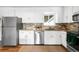 Updated kitchen with modern appliances, granite countertops, and ample cabinet space for storage at 3322 Simms St, Wheat Ridge, CO 80033