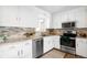Bright kitchen features stainless steel appliances, stone countertops, tile backsplash, and white cabinets at 3322 Simms St, Wheat Ridge, CO 80033