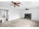Open living room with fireplace and two ceiling fans at 3322 Simms St, Wheat Ridge, CO 80033