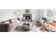 Bright living room with a stone fireplace, plush mauve couch, and modern decor at 3322 Simms St, Wheat Ridge, CO 80033