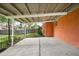 Covered concrete patio with a metal railing and a view of the backyard at 3322 Simms St, Wheat Ridge, CO 80033