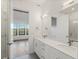 Bright bathroom boasts double sinks, quartz countertops, and a view of nature from bedroom at 3909 Piney Grove St, Evergreen, CO 80439
