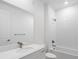 Bright, clean bathroom with modern fixtures, white tiling, and a shower-tub combo at 3909 Piney Grove St, Evergreen, CO 80439